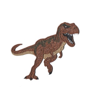 Könnte beinhalten: Gestickter Aufnäher eines braunen Tyrannosaurus Rex Dinosauriers mit grünen Akzenten, der mit offenem Maul brüllt.