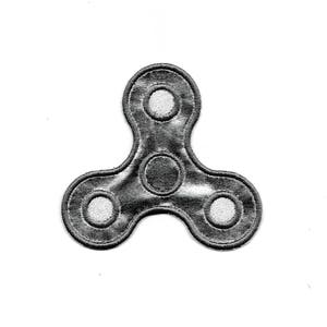 May include: A black and white embroidered fidget spinner patch. The patch has three arms with a circle in the center and a circle on each arm.