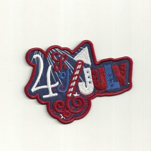 May include: Red, white and blue embroidered patch with the text "4th of July" in a stylised font. The patch features a firework and stars.