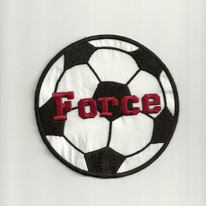 May include: A black and white soccer ball with the word "Force" embroidered in maroon on the front.