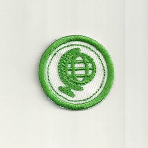 May include: Green embroidered patch with a white background featuring a globe design.