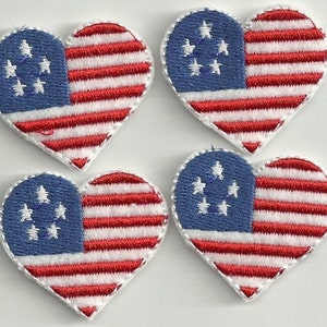 May include: Four red, white, and blue heart-shaped American flag patches. Each patch is about 1.5 inches wide and 1.75 inches tall.