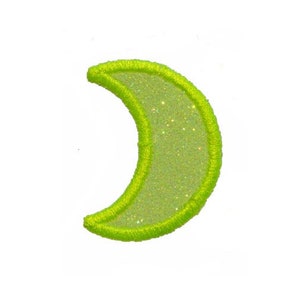 May include: A lime green crescent moon shaped patch with a glittery surface.