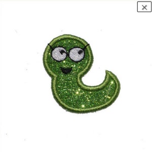 May include: Green glitter iron-on patch of a cartoon worm wearing glasses and smiling.