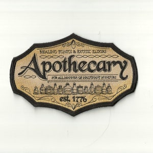 May include: A gold and black embroidered patch with the text "HEALING TONICS & EXOTIC ELIXIRS Apothecary FOR ALL MANNER OF MALIGNANT HUMDURS est. 1776".