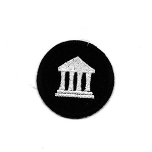May include: A black and white embroidered patch featuring a white building with columns on a black circle background.