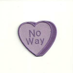 May include: Purple heart-shaped patch with the text "No Way" embroidered in white.