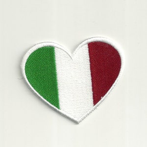 May include: A white heart-shaped patch with the Italian flag colors: green, white, and red.