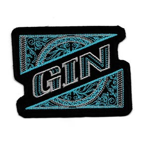 Può includere: Toppa ricamata nera e blu con la parola "GIN" in lettere argentate.