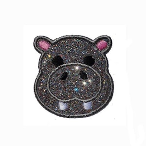 May include: A sparkly gray hippopotamus face with pink ears. The hippopotamus is a popular animal for children's clothing and accessories.