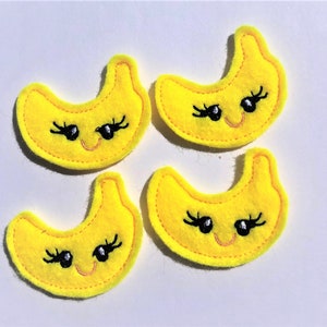 May include: Four yellow felt banana appliques with embroidered black eyes and eyelashes and a pink smile.