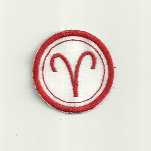May include: Red embroidered iron-on patch with a white Aries zodiac symbol inside a white circle.