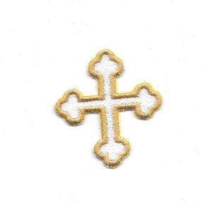 May include: A white cross with a gold outline. The cross has a simple, traditional design.