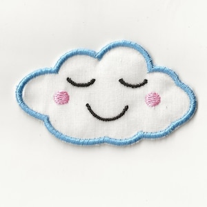 May include: A blue embroidered cloud with a smiling face, closed eyes, and pink cheeks.