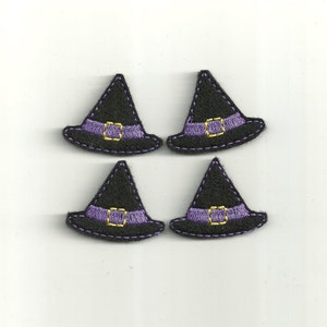 May include: Four black felt witch hats with purple trim and gold buckles. The hats are approximately 2 inches tall.