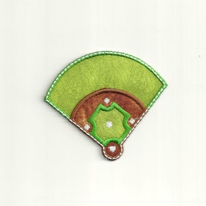 May include: Green and brown felt baseball field patch with white stitching. The patch is shaped like a half circle and has a diamond in the center.
