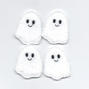 May include: Four white felt ghost appliques with black embroidered eyes and smiling mouths.