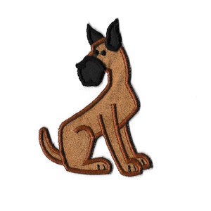 Può includere: Un toppa ricamata raffigurante un cane di cartone animato seduto con le orecchie dritte, in marrone e nero.