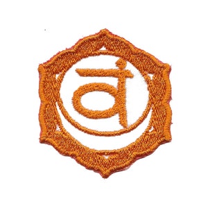 May include: Orange embroidered patch with a white background and the Sanskrit symbol for the sacral chakra, Svadhisthana, which is a stylized "a".