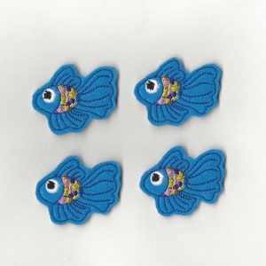 May include: Four blue felt fish appliques with embroidered details. Each fish has a white eye, a yellow mouth, and purple and gold scales.