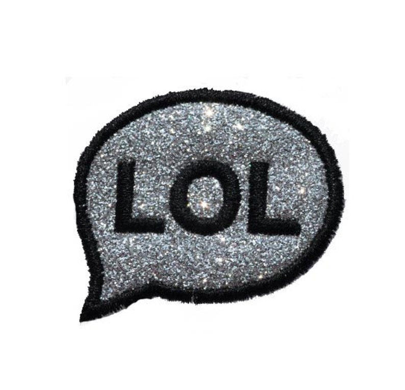 May include: A silver glitter speech bubble with the word "LOL" in black lettering.