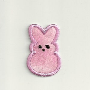 May include: Pink felt bunny shaped patch with black embroidered eyes.