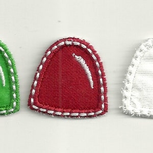 May include: Three felt Christmas decorations in the shape of bells. The bells are green, red and white.