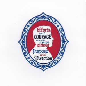 May include: A red and blue embroidered patch with a white silhouette of a person's head. The patch features the text "Efforts and Courage are not enough without Purpose and Direction".