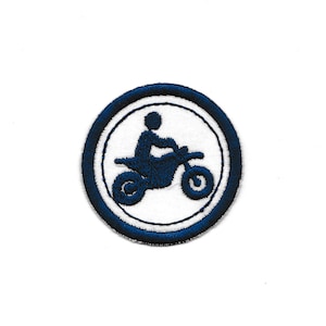 May include: A blue and white embroidered patch featuring a silhouette of a person riding a dirt bike.