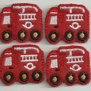 May include: Four red felt appliques of a fire truck with white embroidered details. Each truck has a ladder, wheels, and a white embroidered circle on the side.