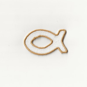 May include: White embroidered iron-on patch in the shape of a fish with a gold outline.