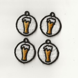 May include: Four white round embroidered patches with a black outline. Each patch features a brown beer glass with white foam on top.