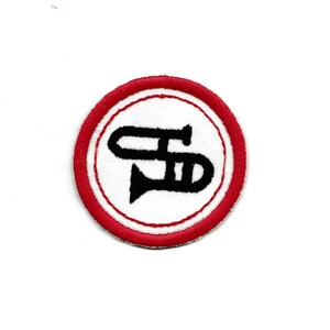 May include: A red and white embroidered patch with a black trumpet in the center.