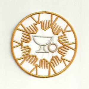 May include: A white embroidered patch with a gold outline. The patch features a chalice and host, a common symbol of the Eucharist.