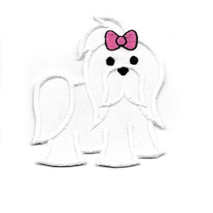 May include: White embroidered iron-on patch of a Maltese dog wearing a pink bow.