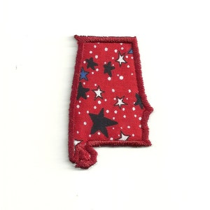 May include: Red fabric patch in the shape of the state of Alabama with a white and black star pattern.