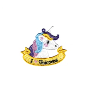 May include: An embroidered iron-on patch featuring a white unicorn with a purple, blue, and yellow mane and horn. The unicorn is holding a yellow banner with the text "I love unicorns" in black.