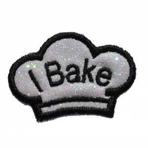 May include: White chef's hat with black outline and glitter, with the text "I Bake" in black.