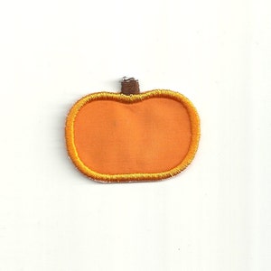 May include: Orange felt pumpkin applique with a brown felt stem. This applique is perfect for adding a touch of fall to your crafts.