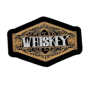 May include: A black and gold embroidered patch with the word "WHISKEY" in white lettering.
