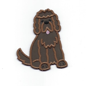 May include: Brown embroidered iron-on patch of a sitting dog with a pink tongue.