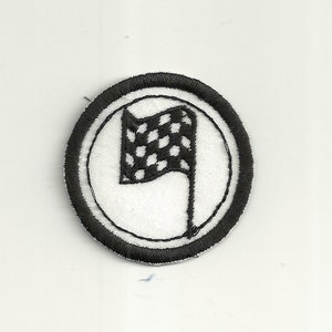 May include: Black and white checkered flag embroidered on a white circle with a black border. The circle is surrounded by a black border.