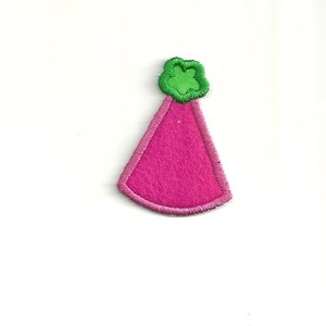 May include: A pink felt party hat with a green felt top. The hat is a simple design with a rounded top and a pointed bottom.