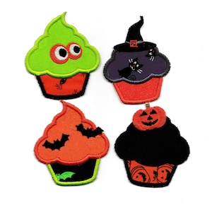 May include: Four Halloween-themed cupcakes with different decorations. One cupcake has green frosting with googly eyes, another has purple frosting with a witch's hat and black cats, another has orange frosting with bats, and the last one has black frosting with a jack-o'-lantern on top.