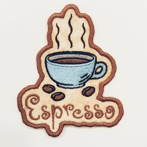 May include: Brown embroidered patch with a blue coffee cup with steam coming out of it and the word "Espresso" written in a brown cursive font.