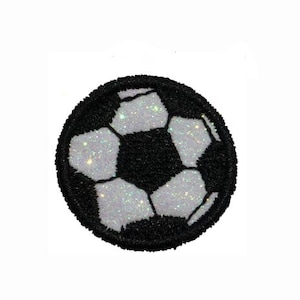 May include: A black and white glitter soccer ball patch. The patch is round and has a white background with black stitching. The soccer ball has a black outline and a white interior.