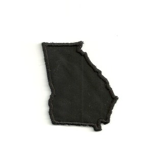 May include: Black fabric patch in the shape of the state of Georgia.