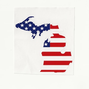 May include: A sticker in the shape of the state of Michigan, featuring the American flag design. The upper peninsula is blue with white stars, and the lower peninsula has red and white stripes.