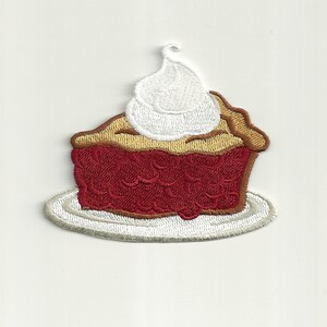 May include: A red embroidered patch of a slice of pie with whipped cream on top, on a white plate.