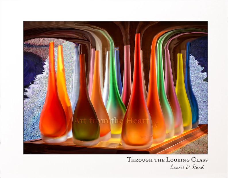 May include: A collection of colorful glass vases in various shades of red, orange, yellow, green, blue, and purple. The vases are arranged in a row on a wooden surface. The text "Art from the Heart" is visible in the image.